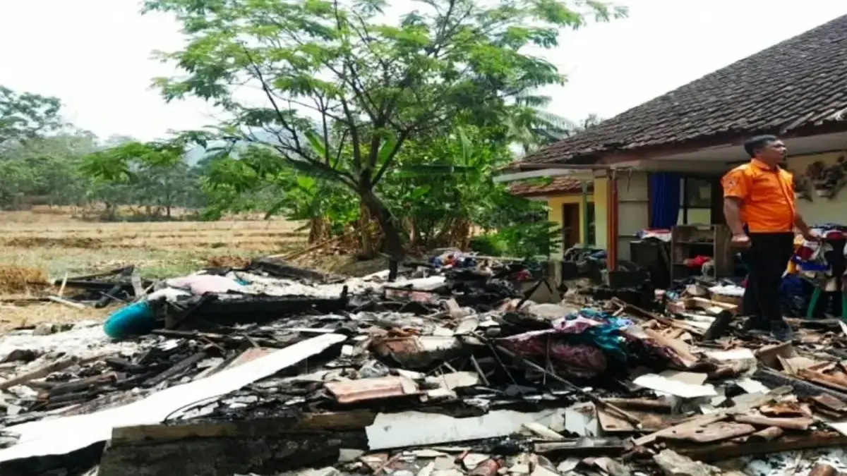 Petugas BPBD Kuningan melakukan penanganan dan asesmen setelah dua rumah warga terbakar di Desa Rambatan